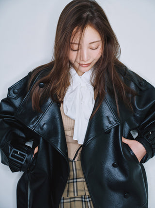 Model wearing the black SNIDEL Stand Collar Belted Jacket open over a white bow blouse.