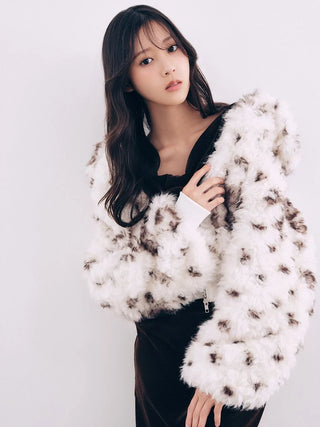 Model wearing the white and brown patterned SNIDEL Faux Fur Blouson over a black top.