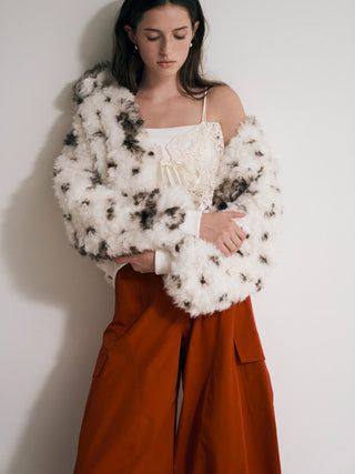 Model wearing the white and brown patterned SNIDEL Faux Fur Blouson draped off one shoulder over a lace top.