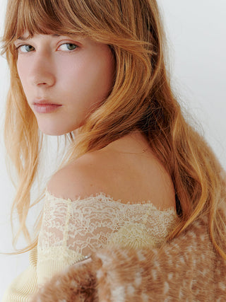 Close-up of a model wearing the brown spotted SNIDEL Faux Fur Blouson draped below a lace-trimmed shoulder.