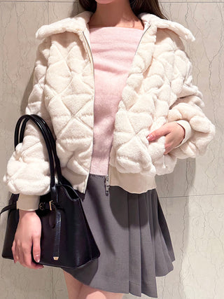 Ivory SNIDEL Faux Fur Blouson worn open over a pink knit top, showing diamond quilting and side pockets.