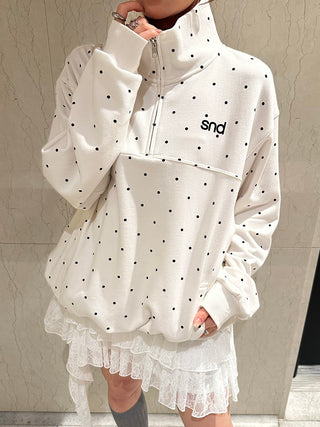 White SNIDEL Twist Frill Mini Skort styled with an oversized white polka-dot half-zip sweatshirt.