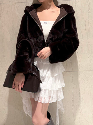 White SNIDEL Twist Frill Mini Skort styled with a dark faux fur jacket, white top and black handbag.