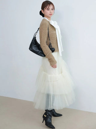 Model wearing the cream SNIDEL Asymmetrical Tulle Volume Skirt with a beige knit top and black boots.