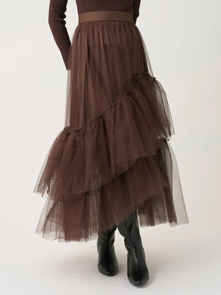 Front view of the brown SNIDEL Asymmetrical Tulle Volume Skirt worn with black boots, showing its uneven tiers.