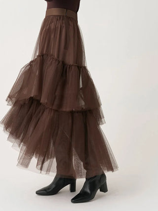 Side view of the brown SNIDEL Asymmetrical Tulle Volume Skirt, showing its airy layers and asymmetric hem.