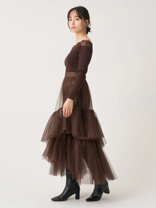 Full-length side view of the brown SNIDEL Asymmetrical Tulle Volume Skirt with a fitted knit top and boots.