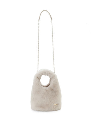 A light beige faux-fur shoulder bag with a circular cutout at the top and a thin silver chain strap, shown against a plain white background.