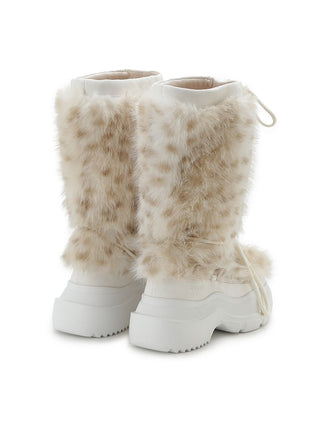 A pair of chunky white platform boots with tall beige faux-fur shafts, shown from a three-quarters angle on a white background.