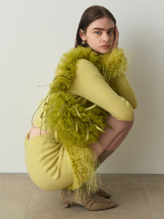 Woman in  Yellow Sleeve Fur Cardigan Sitting