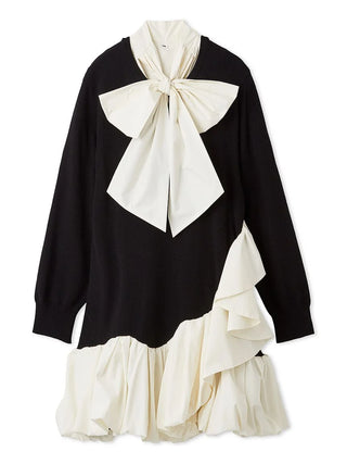 A long-sleeve black knit top with a large cream bow at the collar, layered ruffles on the lower skirt, and a matching cream ruffled hem, shown on a plain white background.