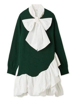 A long-sleeve knit sweater dress in dark green with a large white bow at the collar and a layered white ruffled hem, shown on a plain white background.