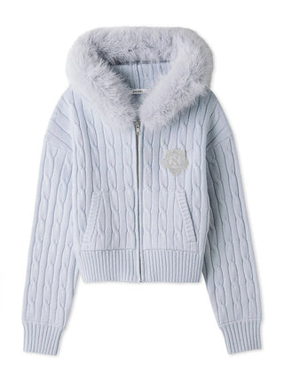 A light blue cable-knit zip-up jacket with a fluffy faux-fur hood trim and a small embroidered crest on the chest, displayed on a clean white background.