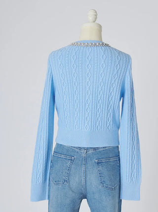 A light blue cable-knit cropped sweater with a beaded neckline, displayed on a mannequin from the back wearing light-wash blue jeans against a light gray background.