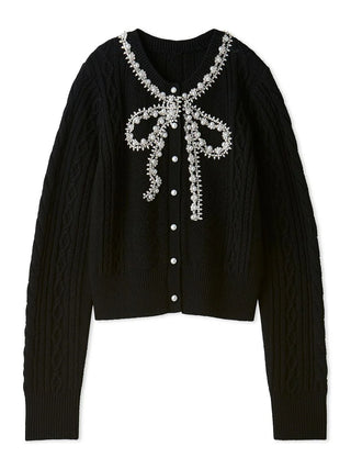 A black cable-knit cardigan sweater featuring a decorative white beaded bow design across the V-neckline and a front button closure, displayed on a clean white background.