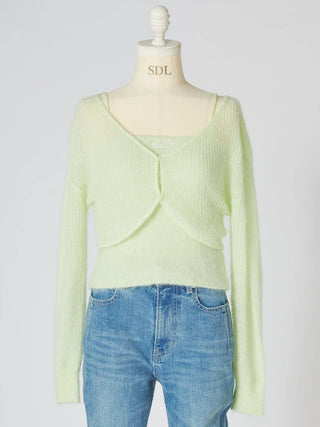 A pale yellow-green knit wrap cardigan sweater displayed on a cream dress form mannequin, paired with blue jeans against a light gray background.