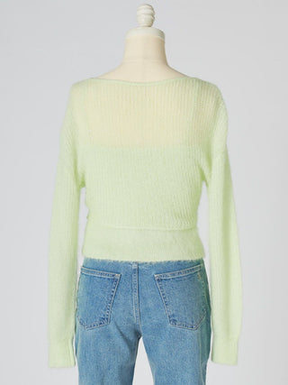 A pale yellow-green ribbed knit sweater displayed on a cream dress form mannequin, paired with blue jeans against a light gray background.