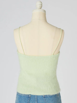 A pale mint green knit camisole top displayed on a cream mannequin torso, paired with blue jeans against a light gray studio background.